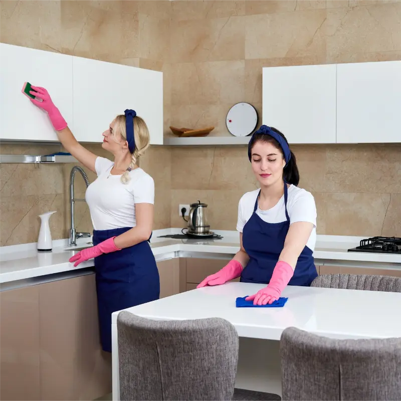 Cleaning services in Burnaby with two professional women cleaners cleaning the kitchen
