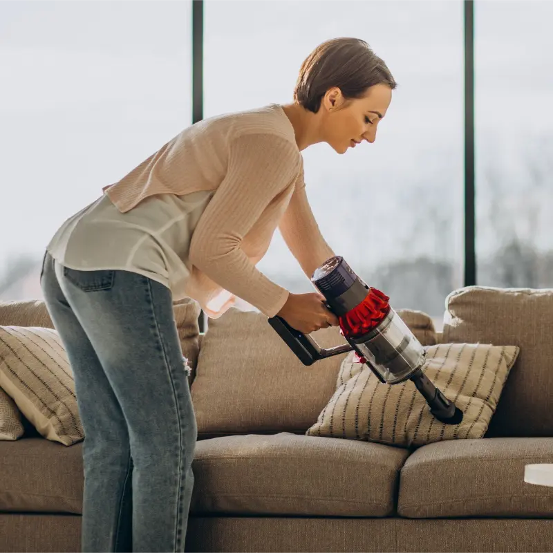 Cleaning services in Burnaby with a professional cleaner working in a modern living room