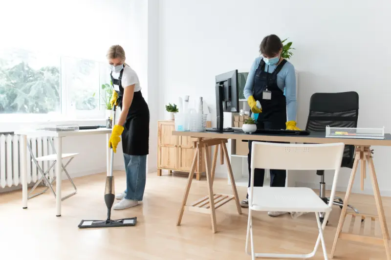 Two women professionals doing deep cleaning in the house