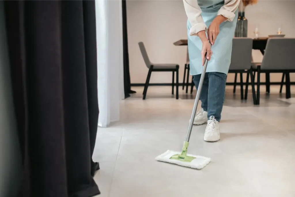 cleaning professional mopping the living room during house cleaning for seniors
