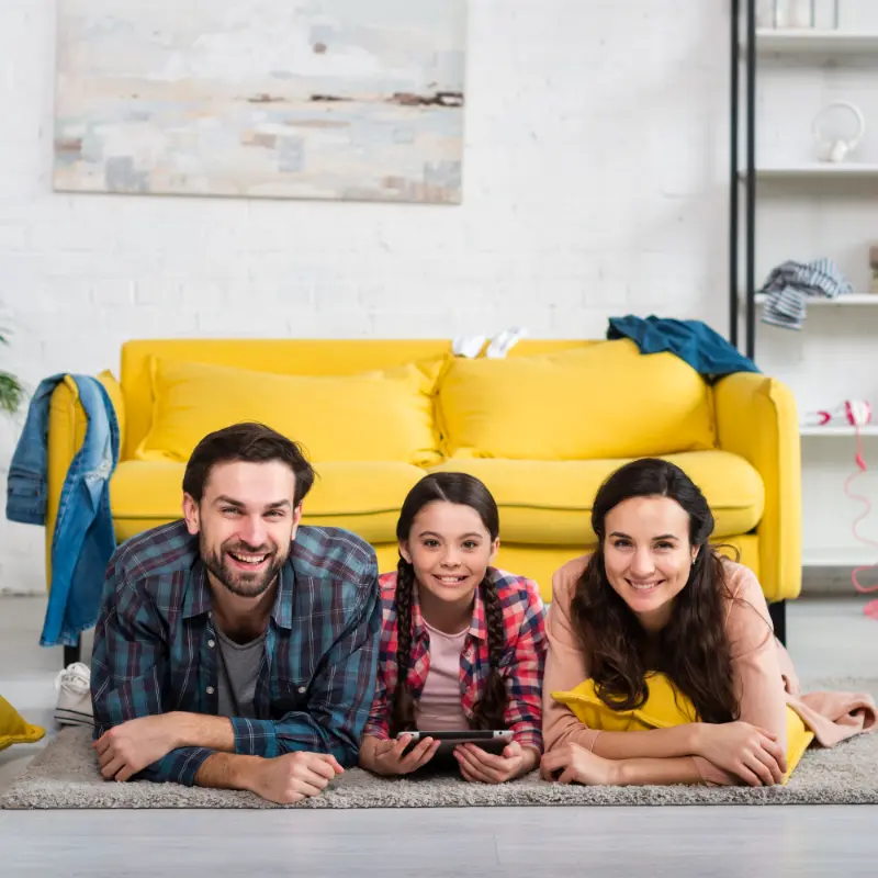 family enjoying special moments together on a carpet after carpet cleaning