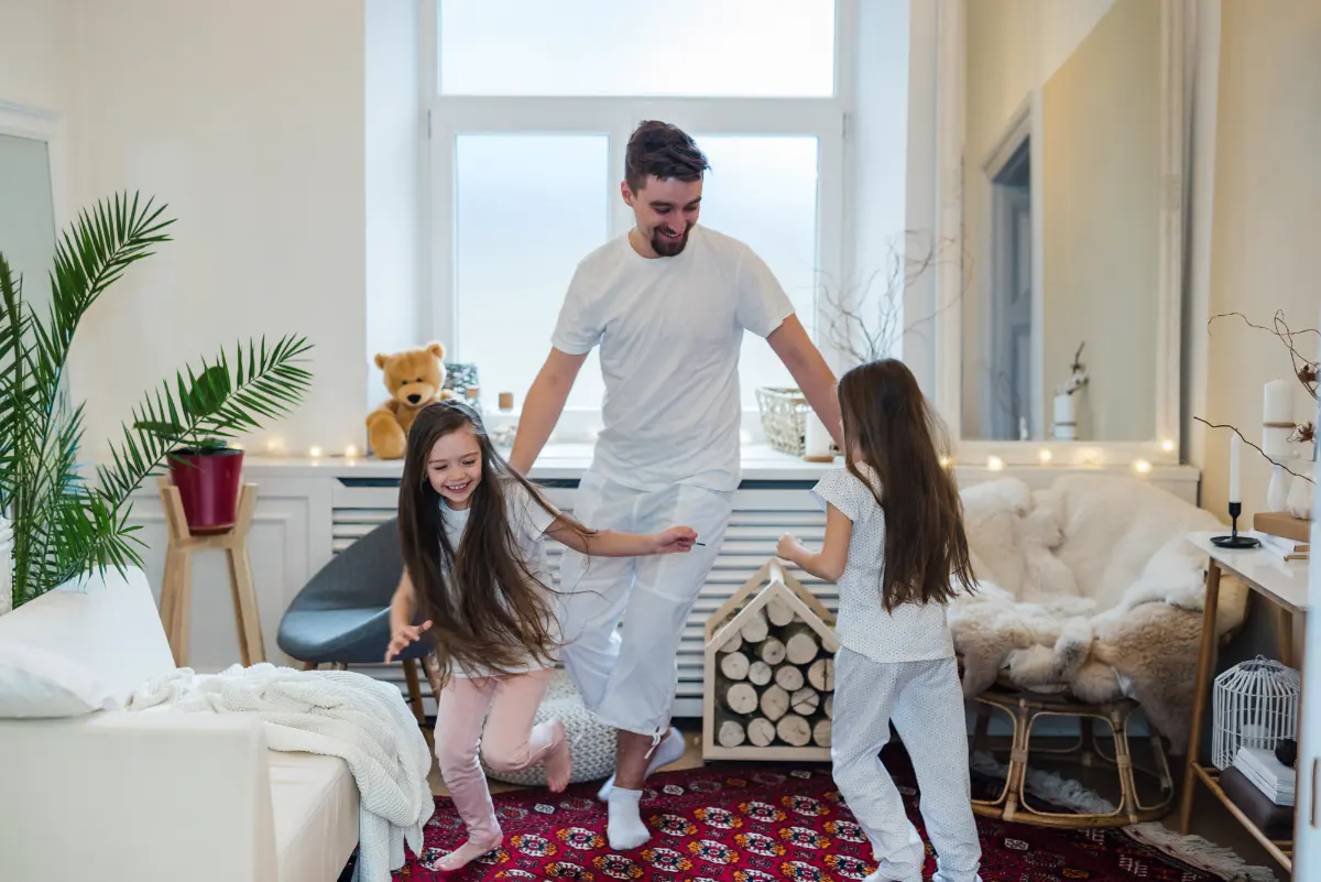 father playing with kids after eco-friendly spring cleaning