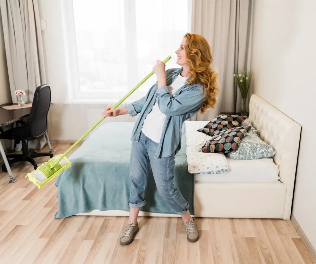 female enjoy cleaning the bedroom during spring cleaning