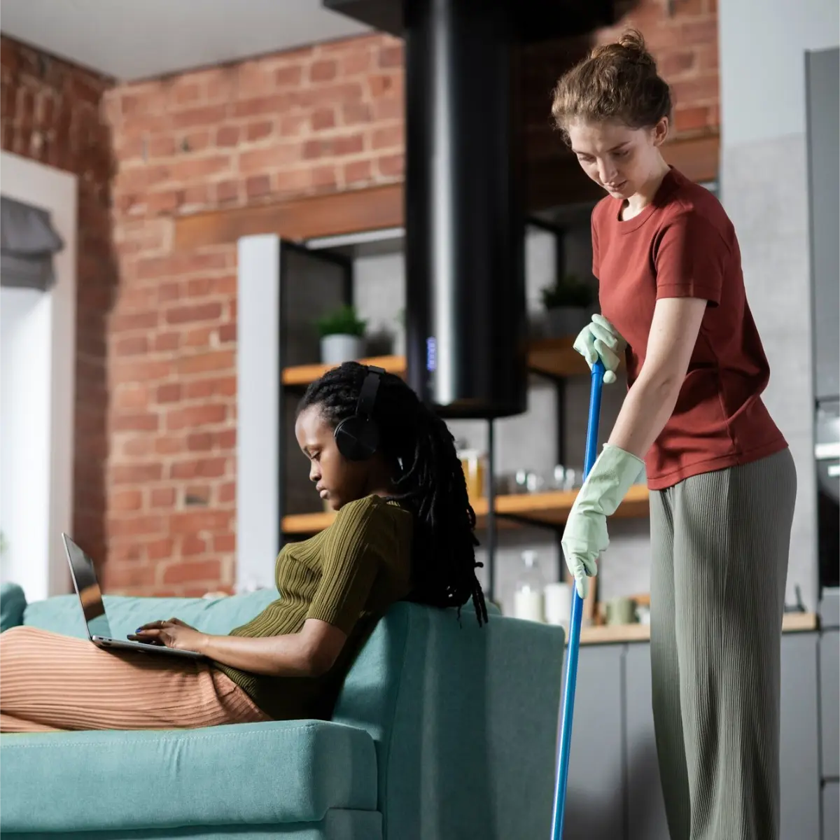 woman relaxing at home while a cleaning professional works.