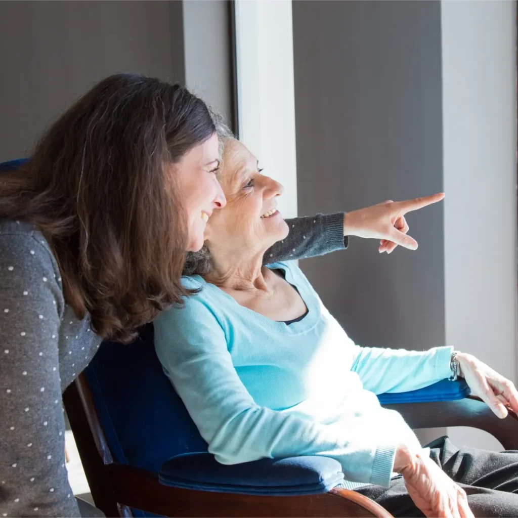 A daughter taking care of her mother while enjoying the view.