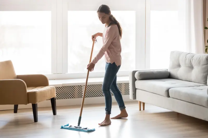 lady cleaning the well-lit living room