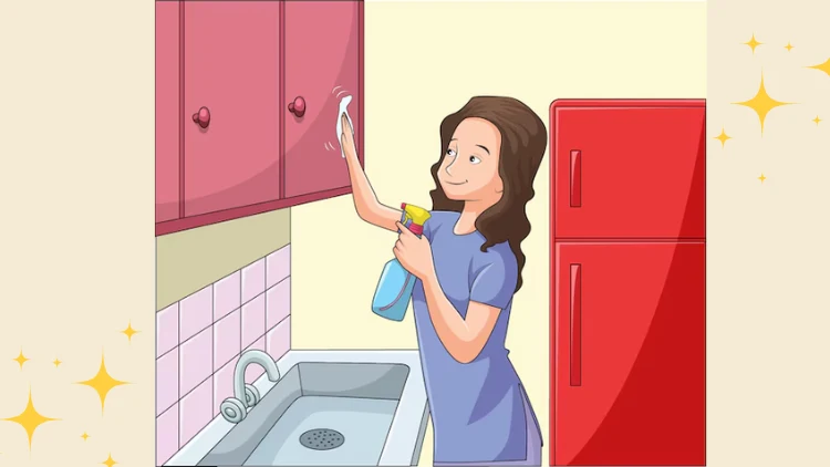 woman wiping the kitchen cabinets while doing deep cleaning in her Port Moody house
