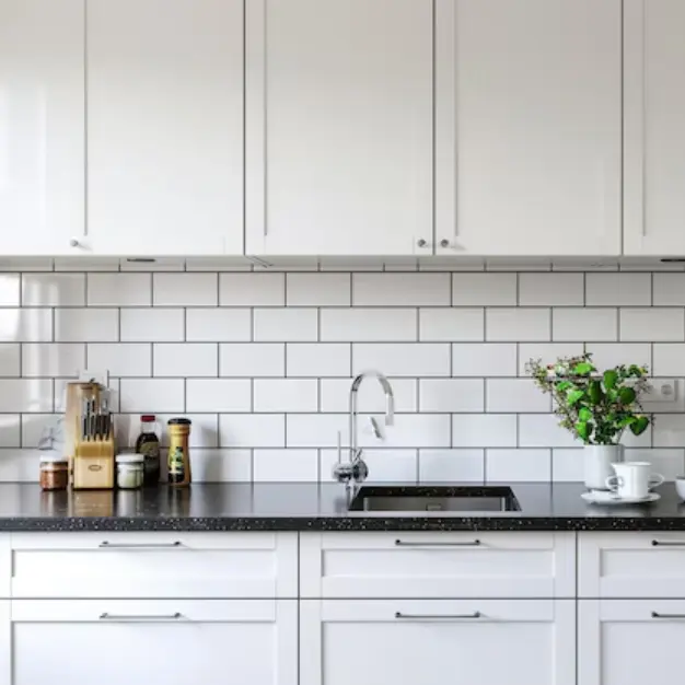 White kitchen cabinets and black countertops
