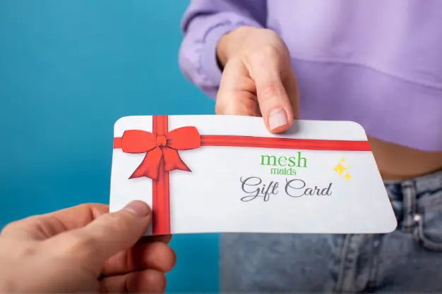 Woman holding Mesh Maids gift card for cleaning services in Burnaby