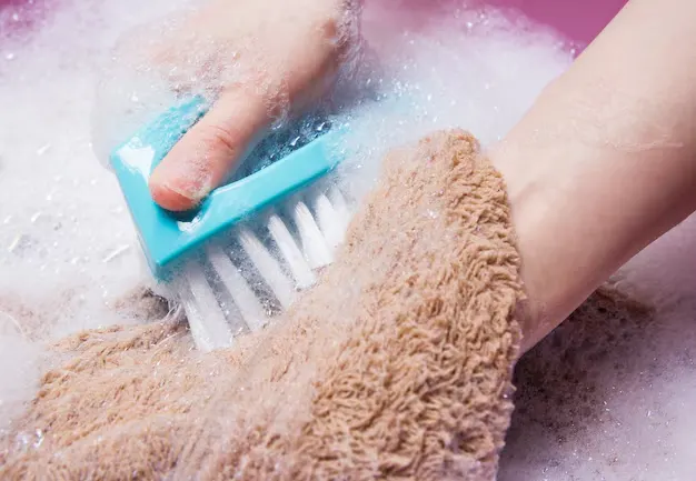 Woman hand washing faux fur