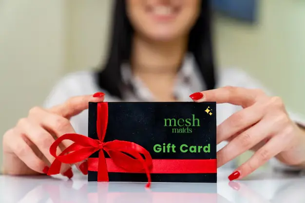 Happy young woman holding a Mesh Maids gift card for cleaning services in North York