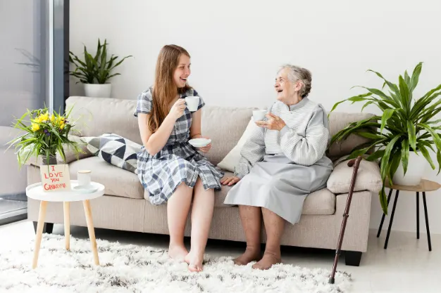 An old lady, spending time with her family and relaxing after choosing mesh Maids' senior-friendly cleaning services in Etobicoke