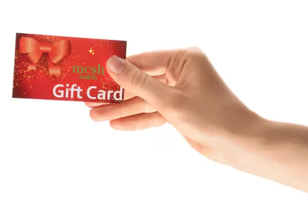 Woman holding Mesh Maids gift card for cleaning services in Ajax