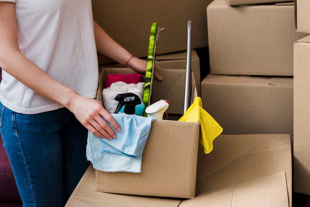 Young female professional holding with supplies during house cleaning services in Markham