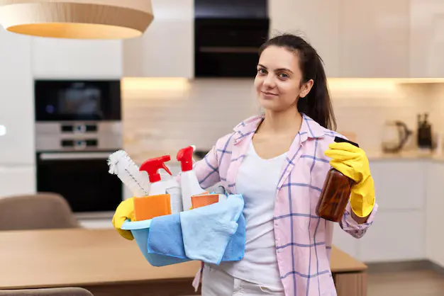 Woman cleaning professional holding cleaning supplies during house cleaning services in Vaughan