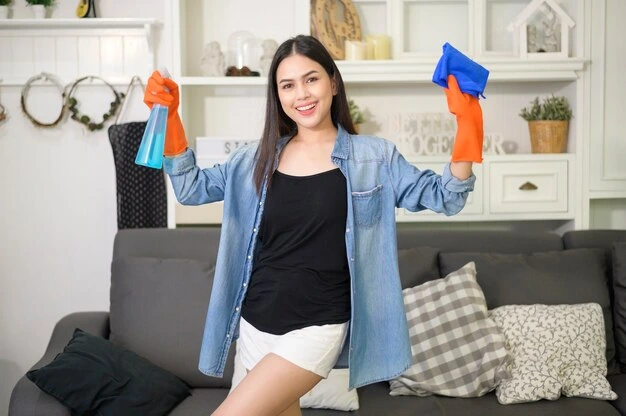 Happy young professional cleaner after a thorough house cleaning services in Ajax