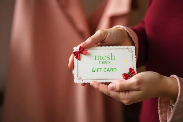 Young woman holding a Mesh Maids gift card for house cleaning services in Edmonton