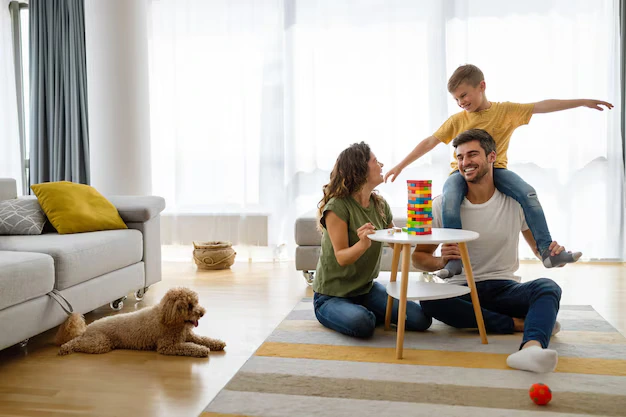 Happy family enjoying with kid at home after house cleaning services in Oshawa