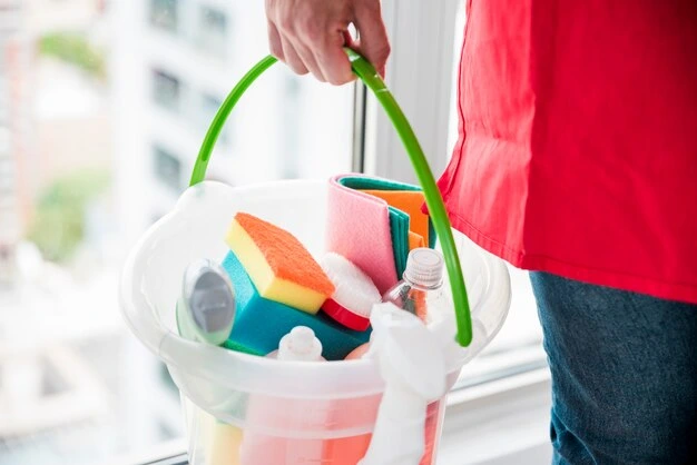 Woman with bucket and cleaning products during house cleaning services in Oakville