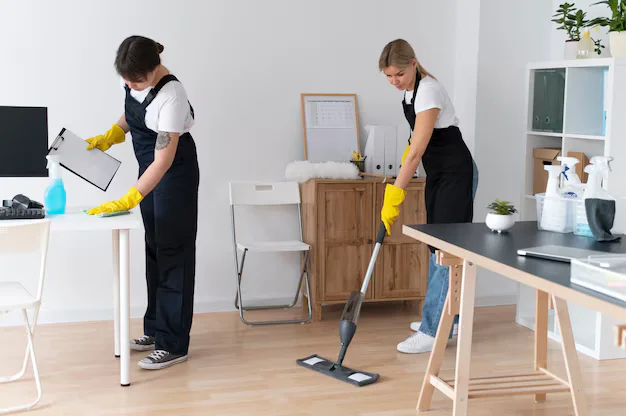 Two women professional cleaning living room during professional house cleaning services in Mississauga and Brampton