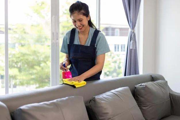 Woman professional cleaner cleaning in living room during house cleaning services in Mississauga and Brampton