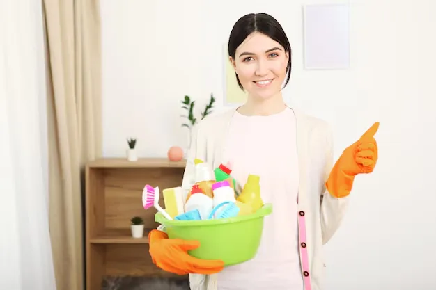 Young happy woman professional standing confidently after house cleaning services in Milton