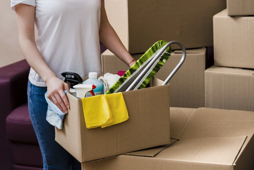 Mesh Maids cleaner holding cleaning supplies during move-out cleaning services
