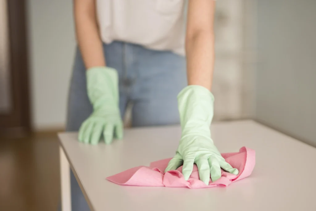 Mesh Maids cleaner disinfecting table in the condo during condo cleaning services